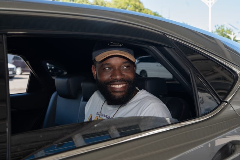 Happy passenger smiling in the backseat